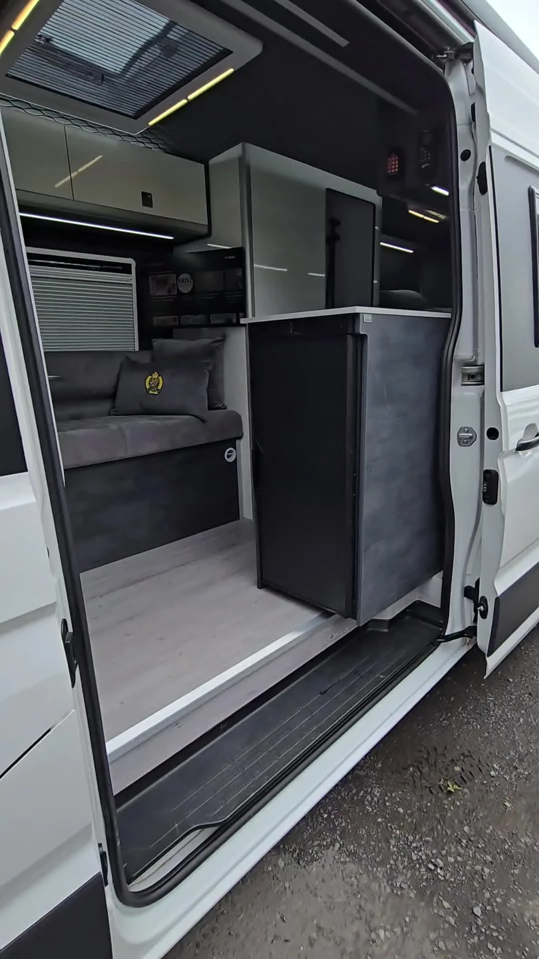 A 2017 on VW Crafter LWB from the sliding door: kitchen pod, seating and top lockers