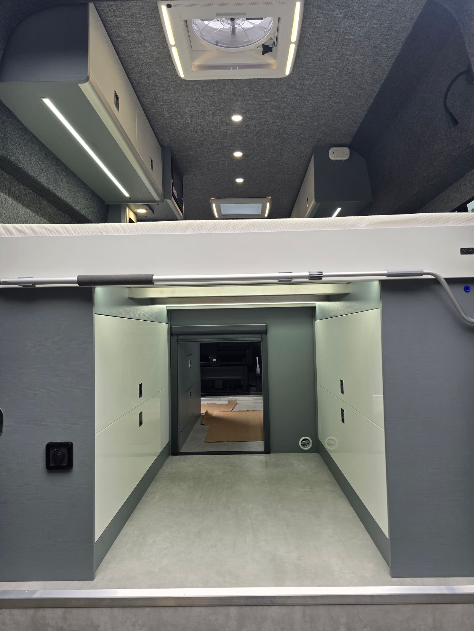 Monument grey bed boxes with white gloss doors under a fixed bed