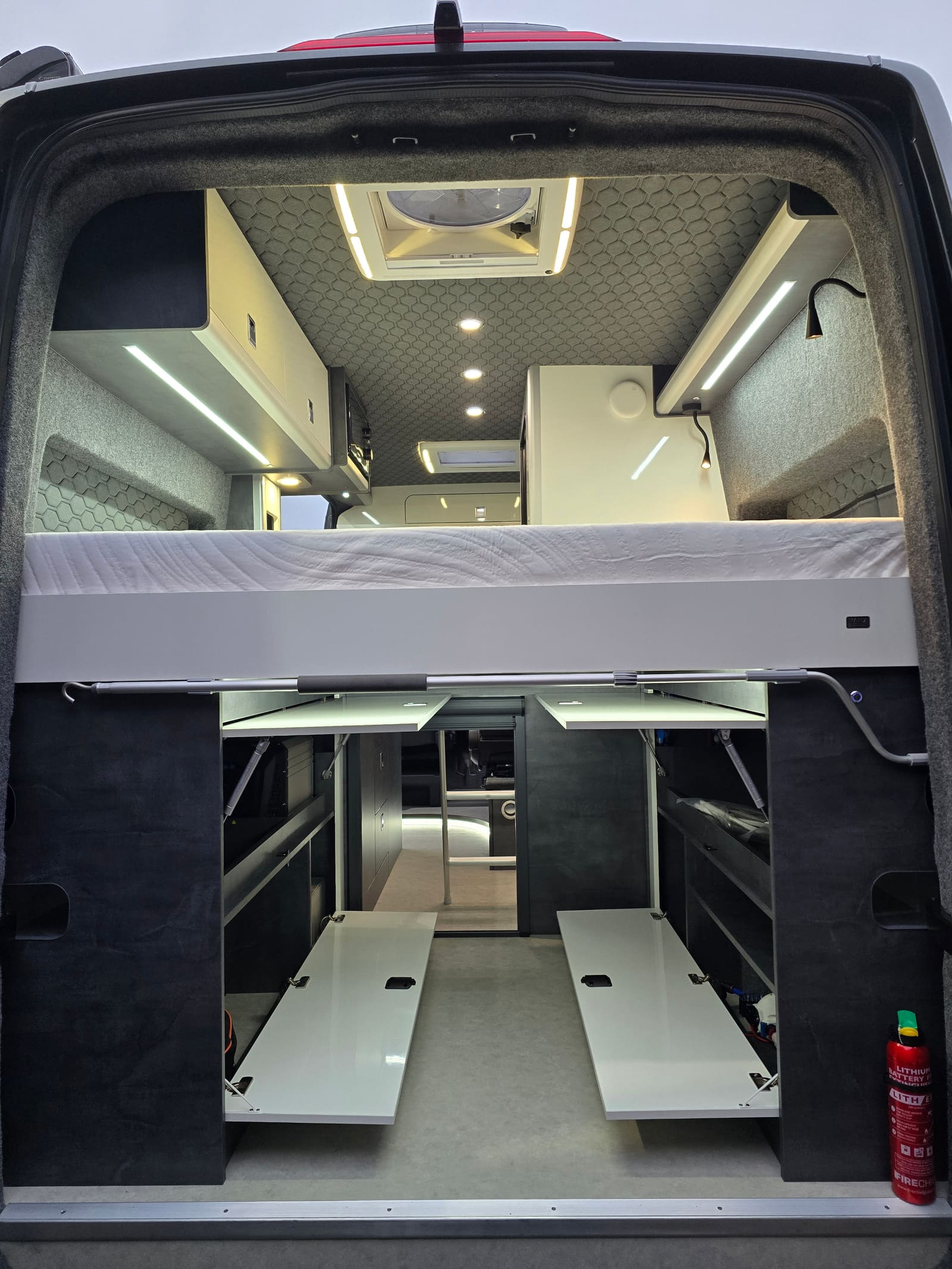 A slate grey bed box system with white gloss doors open, seen from the back doors