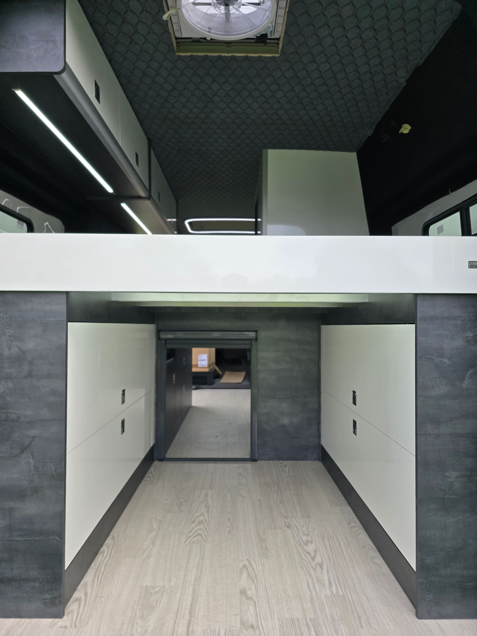 Slate grey bed boxes with white gloss doors under a fixed bed